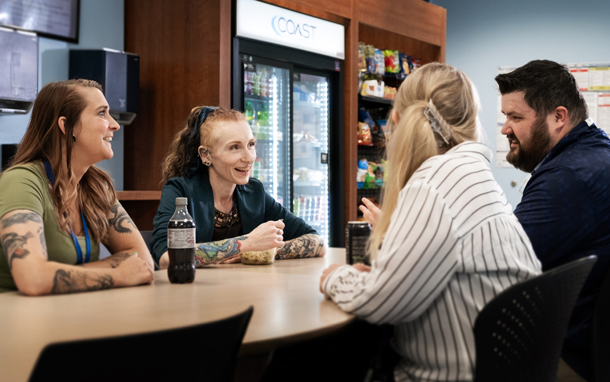 four pals in a breakroom