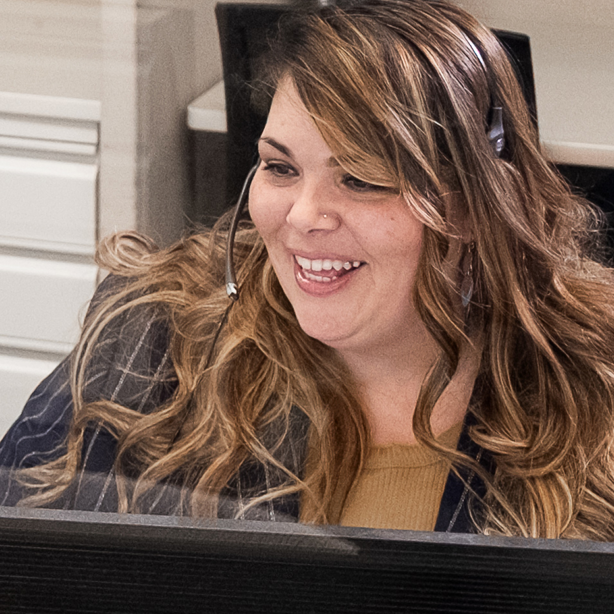 Woman with big smile on headset