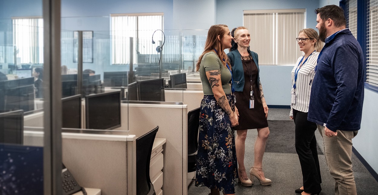 Three people standing in office